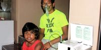 Alex Muthusamy (13) with his brother Jordan (5) photographed in 2020 at their home in Merebank, a residential area with one of the highest asthma rates in the country. (Photo: Tony Carnie)