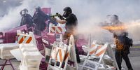 Police officers move to clear activists from a makeshift barricade during immigration raid protests near the Edward R Roybal Federal Building in LA on 8 June. (Photo: Caroline Brehman /  EPA-EFE)