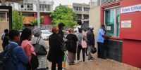 Bus commuters line up to buy a bus ticket home at Claremont Station, Cape Town during peak hour. (Photo: Julia Evans)