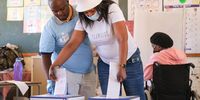 An IEC staff member assists a voter in Bloemfontein, Free State on 1 November 2021 during the local government elections. (Photo: Lihlumelo Toyana)