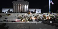 The national flag flies at half staff as people gather to mourn the passing of Supreme Court Justice Ruth Bader Ginsburg at the steps in front of the Supreme Court on September 18, 2020 in Washington, DC. Ginsburg has died at age 87 after a battle with pancreatic cancer. (Photo by Tasos Katopodis/Getty Images)