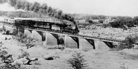 The first train to cross the new bridge at Upington in 1935. (Image Courtesy Stolper & Sons Archives)<br>
