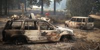 JANESVILLE, CALIFORNIA - AUGUST 17: Fire damaged cars sit on a property that was destroyed by the Dixie Fire on August 17, 2021 near Janesville, California. The Dixie Fire has burned over 604,000 acres, has destroyed over 1,000 homes and threatens thousands more. The fire, the largest single fire in California state history, is 31 percent contained. (Photo by Justin Sullivan/Getty Images)