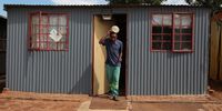 Samuel Manamela, caretaker at the Malusi Youth Development Centre, walks out of his solar-powered home. (Photo:Felix Dlangamandla)<br>