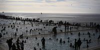 Crowds of people pack the public swimming pools in Sea Point as the sun sets on a hot day in Cape Town on 16 January 2016. (Photo: EPA /  Kim Ludbrook)