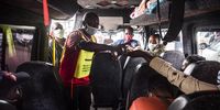 An image taken from inside a taxi as a marshal sanitises the hands of passengers who will be traveling to the Zimbabwean border at Johannesburg’s Wanderers long distance taxi rank on 17 December 2020. (Photo: Shiraaz Mohamed)