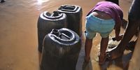 A boy helps his brother draw water at a communal borehole in Muyexe. Residents walk long distances using wheelbarrows and donkey carts to fetch water from boreholes. (Photo: Lucas Ledwaba / Mukurukuru Media)