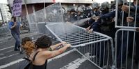 A woman tries to remove a police barricade during a protest against copper mining in front of the National Assembly in Panama City, Panama 28 August 2023. More than a hundred people protested against a new contract of Minera Panama, a subsidiary of Canadian First Quantum Minerals, that operates the largest open-pit copper mine in Central America, under a tense atmosphere and clashes with police that left some minor injuries.  EPA-EFE/Bienvenido Velasco