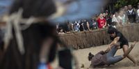 Competitors during the wrestle Huka-huka of the indigenous games of Peruibe on the coast of Sao Paulo, Brazil, 21 July 2024. The Peruibe Indigenous Games, which take places over three days, includes events such as archery, Huka-huka, log race, tug of war, spear, blowgun, in addition to songs, dances, and cultural presentations.  EPA-EFE/Isaac Fontana