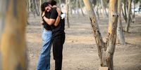 A man and a woman embrace as family members and friends of the lost and kidnapped gather at the site of the Nova Festival to mark the one year anniversary of the attacks by Hamas, on October 07, 2024 in Re'im, Israel. Various commemorations are taking place around Israel to mark the  anniversary of the Hamas attacks in Israel. On October 7, 2023, members of Hamas mounted a series of attacks and raids on Israeli citizens in the Gaza Envelope border area of Israel. 251 Israelis and foreigners were kidnapped with nearly 100 still unaccounted for and 1139 people were killed. (Photo by Leon Neal/Getty Images)