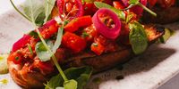 Fresh and roasted baby tomatoes, basil, red onion and aioli on toasted garlic ciabatta. (Photo: Jenni Elizabeth)