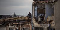 epa09300191 A man stands on the roof of a damaged house after a tornado hit in Mikulcice, Czech Republic, 25 June 2021. A rare tornado on 24 June evening swept through the region of South Moravia, in south-eastern Czech Republic, leaving thousands of houses destroyed and damaged, authorities announced. At least three people died, according to a spokesperson of the regional ambulance service.  EPA-EFE/MARTIN DIVISEK