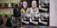 epa09874030 French street artist Jaeraymie pastes elections posters depicting caricatures of French President Emmanuel Macron (L) and French former President Francois Hollande (R) in the streets of Paris, France, 06 April 2022. Jaeraymie says he caricatures French Presidential candidates who stigmatized a social group of people with words or actions. The first round of the French presidential election will take place on 10 April and the second round on 24 April.  EPA-EFE/YOAN VALAT