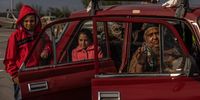 epa09923182 A family waits in a car after arriving from Melitopol to the evacuation point in Zaporizhzhia, Ukraine, 02 May 2022. On 02 May, thousands of people who were still in Mariupol and other areas in South Ukraine occupied by the Russian army, waited to be evacuated to Ukraine's controlled area by buses and their own cars.  EPA-EFE/ROMAN PILIPEY