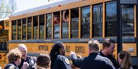 School buses with children arrive at Woodmont Baptist Church to be reunited with their families after a mass shooting at The Covenant School on March 27, 2023 in Nashville, Tennessee. According to initial reports, three students and three adults were killed by the shooter, a 28-year-old woman. The shooter was killed by police responding to the scene. (Photo by Seth Herald/Getty Images)