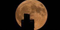 The June full moon, known as the Strawberry Moon, rises behind Victoria Tower in Huddersfield, West Yorkshire, Britain, 03 June 2023.  EPA-EFE/ADAM VAUGHAN