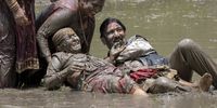 Nepalese farmers lie in muddy water in a paddy field on National Paddy Day in Jitpurphedi village, on the outskirts of Kathmandu, Nepal, 29 June 2025. On this day, locally known as Asar Pandra, farmers begin the annual rice planting season and perform various festivities such as preparing rice meals with muddy water, mud being a symbol for a prosperous season.  EPA/NARENDRA SHRESTHA