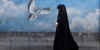 A veiled Iranian woman walks past a wall painting of a peace bird in a street in Tehran, Iran, 19 August 2024. Tension remains high between Iran and Israel since late Hamas leader Ismail Haniyeh was killed in Tehran on 31 July 2024, as Iran's leader Ayatollah Khamenei vowed for a 'harsh punishment' against Israel in retaliation over the killing of Haniyeh. The US and EU administrations asked Iran not to attack Israel as peace talks between Hamas and Israel are going on.  EPA-EFE/ABEDIN TAHERKENAREH
