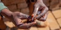 A Nyaope addict prepares his next hit, Johannesburg, South Africa. (Photo: Sharon Seretlo / Gallo Images)