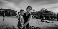 "Venezuelan Migrant, Colombia 7." A Venezuelan mother and her young child wait for relief aid in the border city between Venezuela and Colombia. New families arrive daily, with the rising cost of living in Venezuela, and lack of jobs. © Jan Grarup, Denmark, Finalist, Professional, Documentary Projects, 2022 Sony World Photography Awards