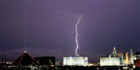 LAS VEGAS, NEVADA - JULY 25:  Lightning strikes west of Luxor Hotel and Casino (L) and Excalibur Hotel &amp; Casino during a thunderstorm on July 25, 2021 in Las Vegas, Nevada. The monsoon brought 60-70 mph winds and dumped up to one inch of rain in the area.  (Photo by Ethan Miller/Getty Images)