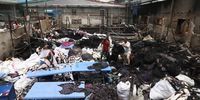 Workers check burnt garments at the S.B. garment factory at Dhaka-Chattanooga area, Dhaka, Bangladesh, 23 July 2024. The Bangladeshi government imposed a nationwide curfew and deployed military forces after violence broke out in Dhaka and other regions following student-led protests demanding reforms to the government's job quota system.  EPA-EFE/MONIRUL ALAM
