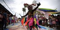 A person dressed as El Gran Diablo (The Great Devil) dances in front of the San Atanasio church, during the celebration of Corpus Christi in Villa de Los Santos, Panama, 08 June 2023. To the rhythm of drums and castanets, dozens of 'devils' with their handmade masks dance into the church of La Villa de Los Santos after being granted 'pardon' by a bishop marking the high point of the traditional Corpus Christi celebration in Villa de Los Santos.  EPA-EFE/Bienvenido Velasco