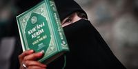 epaselect epa10422823 A female protester holds a Koran as people shout slogans in front of the Consulate General of Sweden during a protest, in Istanbul, Turkey, 22 January 2023. Swedish-Danish far-right politician Rasmus Paludan was permitted to hold a demonstration and burn a copy of the Koran in front of the Turkish embassy in Stockholm on 21 January.  EPA-EFE/SEDAT SUNA