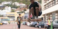 Surfers switch over to skateboarding next to the closed Muizenberg Beach in Cape Town, South Africa, 25 March 2020. After mandating the closure of all beaches throughout the country, the South African government has now announced a nationwide 21-day total lockdown, starting at midnight on 26 March, in a bid to slow down the spread of the ongoing pandemic of the COVID-19 disease caused by the SARS-CoV-2 coronavirus.  (Photo: EPA-EFE/NIC BOTHMA)