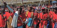 Workers walk on to the field at Sugar Ray Xulu Stadium in Clermont, Durban, for the national Cosatu May Day rally. (Photo: Aisha Abdool Karim)