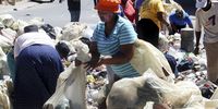 File Photo: Residents try to clear the garbage on the streets on March 28, 2016 in Johannesburg, South Africa. Three children were playing in a heap of rubbish when a gas lamp exploded, leaving them with serious wounds. (Photo by Gallo Images / Sowetan / Antonio Muchave)