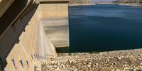 Water markers run up the side of the Darbandikan Dam, Kurdistan, Iraq, October 2021. The water level is at a low unprecedented in its 65 year history, which severely compromises the dam's ability to generate power. (Photo: Susan Schulman)