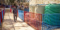 Sierra Nevada Primary School principal Mr Dale Abarahams walks past three jojo tanks that the school installed together with a borehole to overcome the water crisis. 7 September 2022. Lenasia South, Johannesburg. (Photo: Shiraaz Mohamed)