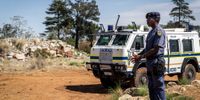 A South African Police Service member stands guard near an entrance to a disused gold mine shaft in Stilfonteinon 17 November 2024. (Photo: EPA-EFE / Stringer)