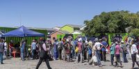 15 March 2022:People queue for sandwiches outside the container across the road from Avril Andrews’ home in Hanover Park.Photographer: Barry Christianson FOR ONCE OFF USE ONLY
