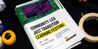 The programme for the community-led Just Transition Festival is displayed on a table. (Photo: Tasha Hoseken- Amehlo Productions.)