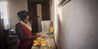 Nyakama prepares to make supper. She is the sole breadwinner in her house and is amazed that she has not contracted the virus. (Photo: Shiraaz Mohamed)