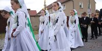 CROSTWITZ, GERMANY - JUNE 16: Girls, wearing traditional Sorbian festive dress known locally as "druzka", participate in the annual Sorbian Corpus Christi Catholic mass and procession on June 16, 2022 in Crostwitz, Germany. Sorbians are a Slavic minority in southeastern Germany who speak a language similar to Czech and Polish. Sorbian is still taught in some schools in the region and a lively tradition of Sorbian literature, theater and folk culture has survived. (Photo by Sean Gallup/Getty Images)