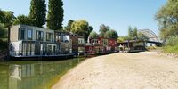 NIJMEGEN, NETHERLANDS - AUGUST 10: Boat houses are seen on the banks of the Waal river on August 10, 2022 in Nijmegen, Netherlands. The ongoing drought and the recurring heat waves have cut operation capacities by half along the lower Rhine from Rotterdam to Germany, an important coal transport route destined to steelmakers and power producers. (Photo by Pierre Crom/Getty Images)