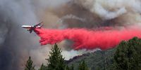 JERSEYDALE, CALIFORNIA - JULY 24: A firefighting aircraft drops retardant ahead of the Oak Fire on July 24, 2022 near Jerseydale, California. The fast moving Oak Fire burning outside of Yosemite National Park has forced evacuations, charred over 14,000 acres and has destroyed several homes since starting on Friday afternoon. The fire is zero percent contained. (Photo by Justin Sullivan/Getty Images)
