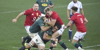 Duhan van der Merwe (centre) of the British & Irish Lions tackled by Franco Mostert (right) of South Africa during the final Test match at Cape Town Stadium on 7 August 2021. (Photo: EPA-EFE / GAVIN BARKER)