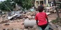 Children left homeless stare at the remains of their home after the floods in Nhlungwane, Ntuzuma. (Photo: Mandla Langa)