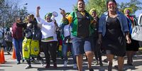 ANC supporters outside the Mbekweni Youth Centre, Paarl, dance prior to President Cyril Ramaphosa's address on Women's Day. 9 August 2018. Photo: Leila Dougan