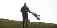 An Israeli soldier carries a Palestinian flag he confiscated from a protester during a demonstration near the Jewish settlement of Bekahot in the Jordan Valley, West Bank. (Photo: Kobi Wolf / Bloomberg via Getty Images)