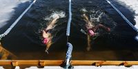 Competitors reach for the wall  during the 200 meter swim portion of the Annual Winter Swimming Festival at Lake Memphremagog in Newport, Vermont, USA, 23 February 2024 (issued 28 February 2024). Every year for the past decade, dozens of swimmers have braved the frigid waters of Lake Memphremagog, which straddles the border between Canada and the United States, for the annual winter swim festival. This year, over 150 cold water swimmers gathered near the small town of Newport, Vermont in late February to spend four days swimming a variety of events in 25-meter lanes that were cut out of the frozen lake, about 300 meters from the shore. Many of the participants have been cold swimmers for several years, with a number of them having started after indoor pools and social distancing regulations were enacted during the Covid-19 pandemic. Others have found mental help and physical relief from cold swimming. Several swim in cold waters nearly everyday of the year. The event at Lake Memphremagog was created 10 years ago by organizer Phil White. After large sections of ice were cut out of the frozen lake for an ice maze, he was asked what to do about the hole left in the ice. He replied: “Well, we could go swimming.” Ten years later, what began as a joke has become an annual tradition that attracts hardy swimmers from around the world to Lake Memphremagog.  EPA-EFE/CJ GUNTHER  ATTENTION: This Image is part of a PHOTO SET