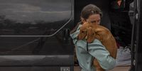 epa09923193 A woman stands with a dog after arriving from the Russian-occupied area in South Ukraine to the evacuation point in Zaporizhzhia, Ukraine, 02 May 2022. On 02 May, thousands of people who were still in Mariupol and other areas in South Ukraine occupied by the Russian army, waited to be evacuated to Ukraine's controlled area by buses and their own cars.  EPA-EFE/ROMAN PILIPEY