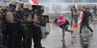 Demonstrators clash with riot police during a protest outside the parliament building in Jakarta, Indonesia, on Thursday, Aug. 28, 2025. Workers rallied to demand higher wages and lower taxes, marking a second major street protest this week that signals growing discontent with President Prabowo Subianto's administration less than a year into his term. Photographer: Dimas Ardian/Bloomberg via Getty Images
