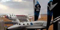 MOJAVE, CA - DECEMBER 7:  A model of SpaceShipTwo is seen with the original SpaceShipOne visible outside as Virgin Galactic unveils its new SpaceShipTwo spacecraft at the Mojave Spaceport on December 7, 2009 near Mojave, California. The eight-person VSS Enterprise, named after the Star Trek ship of the same name, is the first of a series of space-planes for customers of Virgin Galactic who have paid around $200,000 for a suborbital flight into space. British entrepreneur Sir Richard Branson is financing the spacecraft and aerospace designer Burt Rutan is building it through The Spaceship Company, a joint venture of Scaled Composites and Virgin Group.   (Photo by David McNew/Getty Images)
