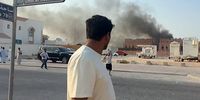 This frame grab taken from AFPTV footage shows a man looking at smoke billowing after explosions in Qatar's capital, Doha, on 9 September. (Photo: Jacqueline Penney / AFPTV / AFP)