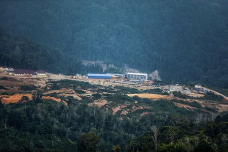 Indonesian town buries its dead in mass grave as flood toll rises